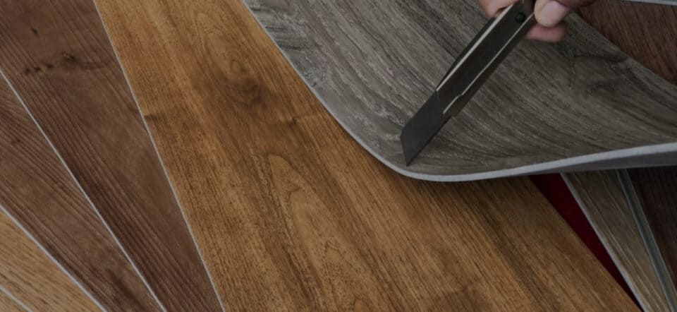 vinyl tiles being cut and installed